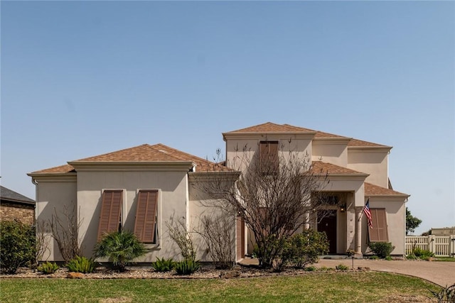 mediterranean / spanish-style house featuring fence and stucco siding