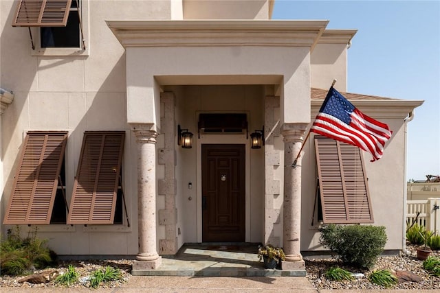 view of exterior entry with stucco siding