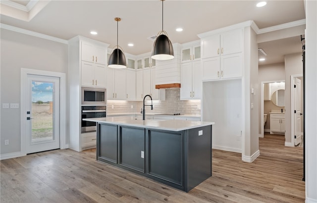 kitchen with glass insert cabinets, light countertops, stainless steel oven, and white cabinetry