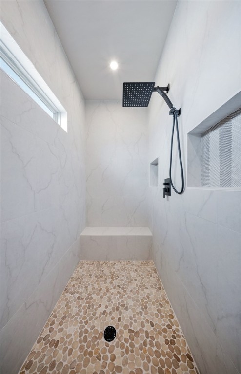 bathroom with tiled shower