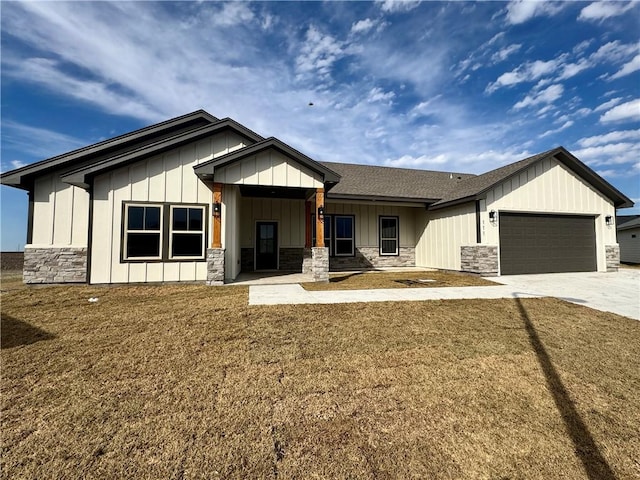 view of front of property with a garage and a front lawn