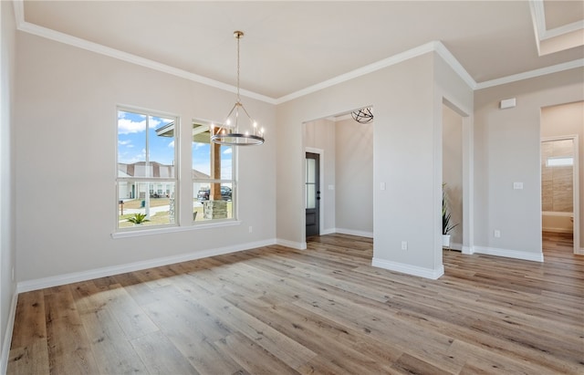 unfurnished dining area with light wood finished floors, baseboards, ornamental molding, and an inviting chandelier