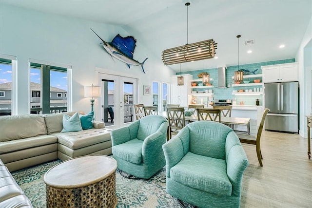 835 Ocean Side Dr, Port Aransas, TX 78373 - living area featuring high vaulted ceiling, light wood finished floors, recessed lighting, and french doors