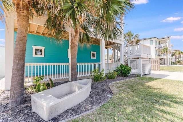 835 Ocean Side Dr, Port Aransas, TX 78373 - view of green lawn with a porch
