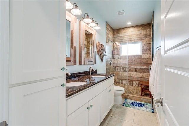 835 Ocean Side Dr, Port Aransas, TX 78373 - full bath featuring toilet, tile patterned floors, double vanity, tiled shower, and recessed lighting