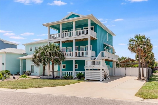 835 Ocean Side Dr, Port Aransas, TX 78373 - coastal home with a balcony and concrete driveway