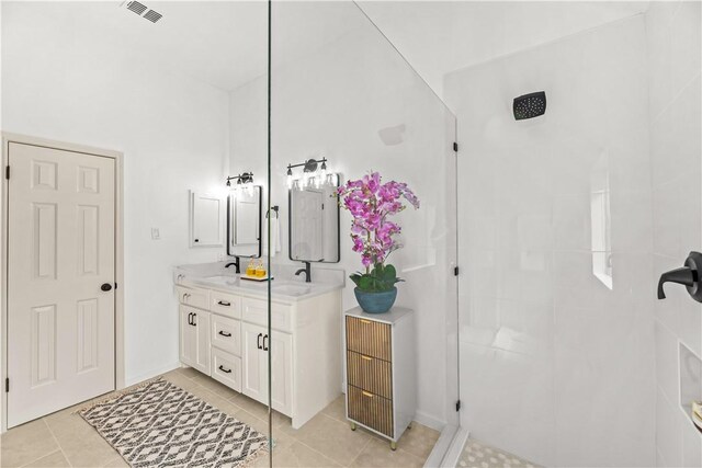 5025 Queens Ct, Corpus Christi, TX 78413 - bathroom featuring double vanity, tiled shower, and tile patterned flooring