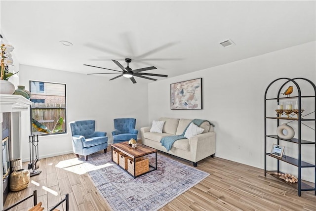 5025 Queens Ct, Corpus Christi, TX 78413 - living area with wood finished floors, ceiling fan, and a glass covered fireplace