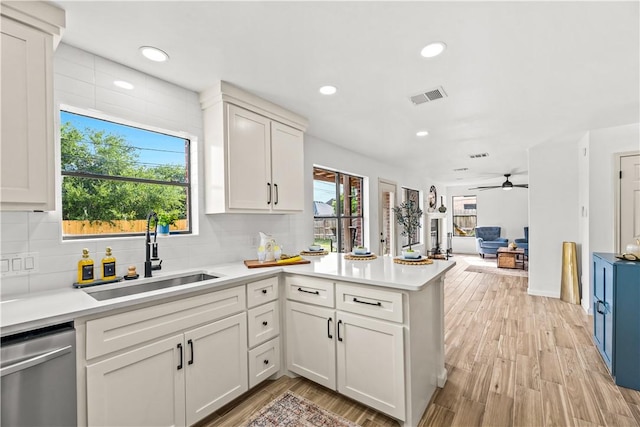 5025 Queens Ct, Corpus Christi, TX 78413 - kitchen with dishwasher, a peninsula, light countertops, tasteful backsplash, and recessed lighting