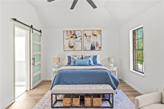 5025 Queens Ct, Corpus Christi, TX 78413 - bedroom with a barn door, vaulted ceiling, light wood-type flooring, and a ceiling fan