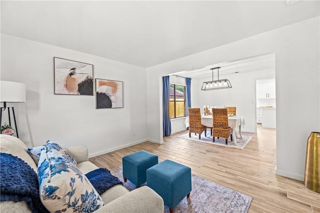 5025 Queens Ct, Corpus Christi, TX 78413 - living room with light wood-style floors and a chandelier