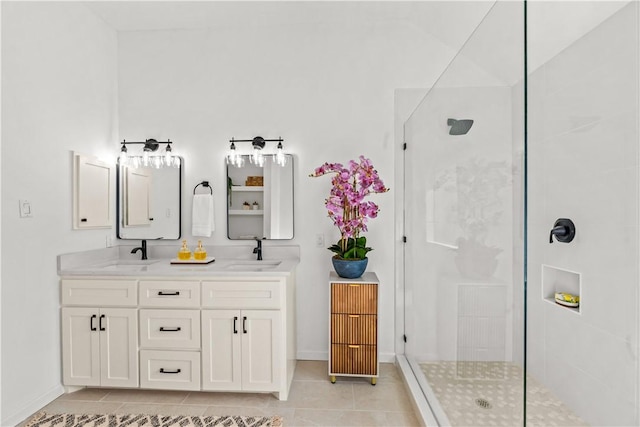 5025 Queens Ct, Corpus Christi, TX 78413 - bathroom featuring tiled shower, double vanity, and tile patterned floors