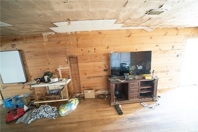 misc room with hardwood / wood-style flooring and wooden walls