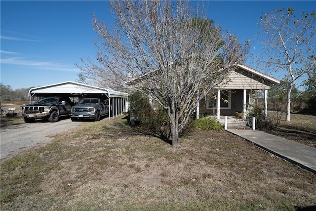 view of front of home with a carport and a porch