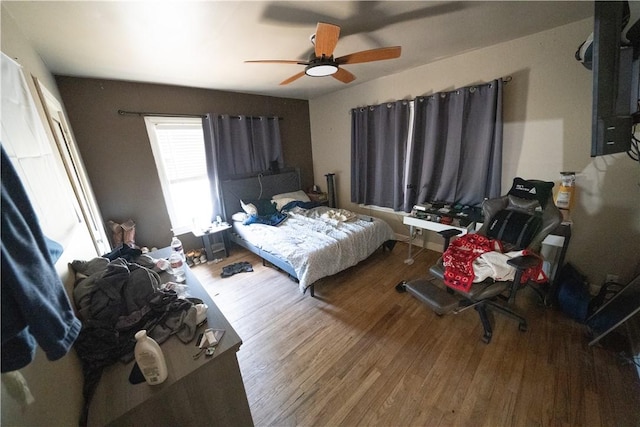 bedroom featuring ceiling fan and hardwood / wood-style flooring