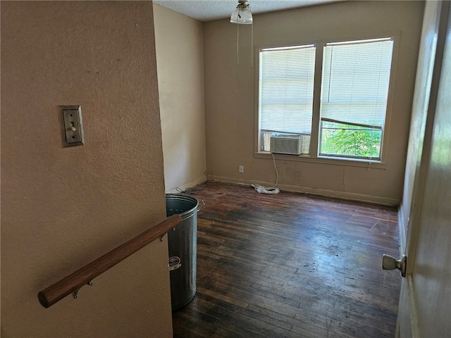 empty room with dark wood-type flooring and baseboards