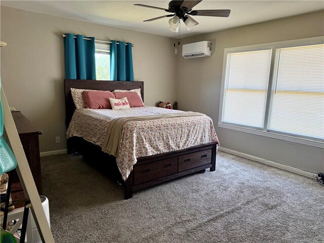 721 S 8th St, Kingsville, TX 78363 - carpeted bedroom featuring a wall unit AC, baseboards, and a ceiling fan