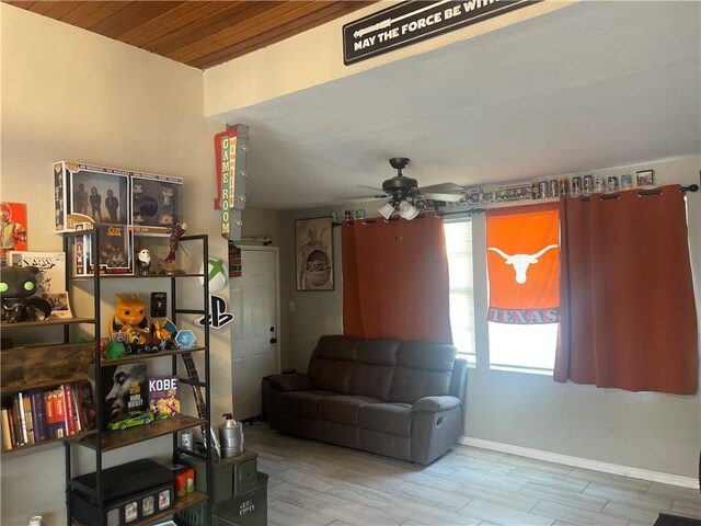721 S 8th St, Kingsville, TX 78363 - living room featuring ceiling fan, wood finished floors, and baseboards