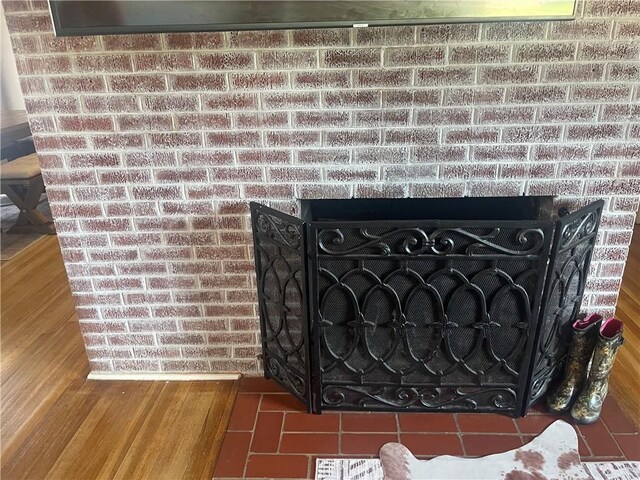 721 S 8th St, Kingsville, TX 78363 - detailed view of a brick fireplace and wood finished floors