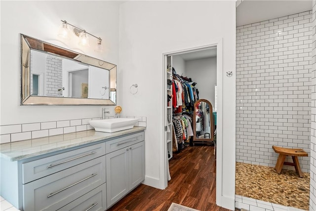 13530 Carlos Fifth Ct, Corpus Christi, TX 78418 - kitchen with a kitchen breakfast bar, appliances with stainless steel finishes, hanging light fixtures, tasteful backsplash, and dark wood-style floors