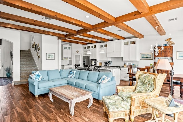 living area with stairway, beam ceiling, and visible vents
