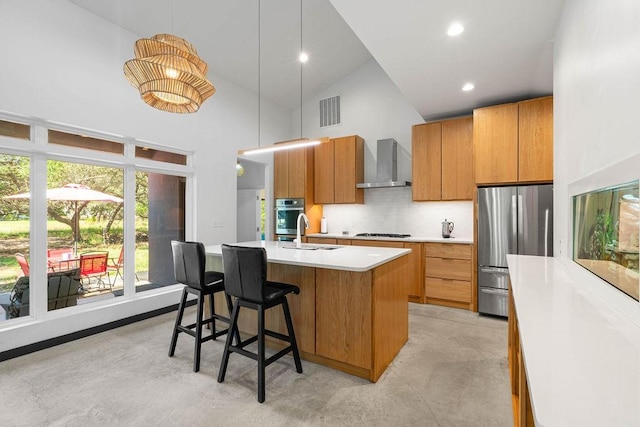 110 Forest Hls, Rockport, TX 78382 - kitchen with stainless steel appliances, wall chimney exhaust hood, brown cabinets, a sink, and light countertops