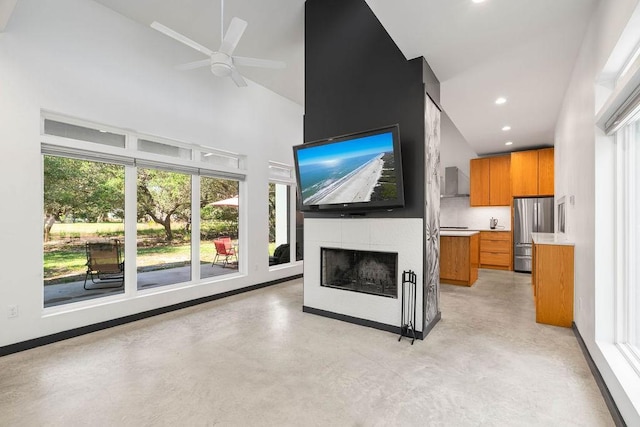 110 Forest Hls, Rockport, TX 78382 - unfurnished living room with high vaulted ceiling, finished concrete flooring, a tile fireplace, a ceiling fan, and recessed lighting