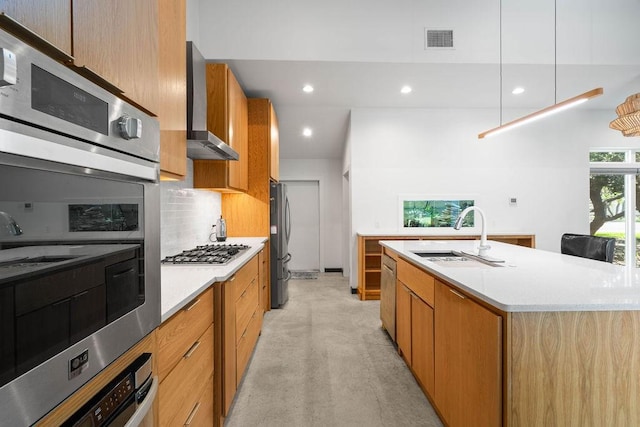 110 Forest Hls, Rockport, TX 78382 - kitchen with a sink, modern cabinets, wall chimney range hood, stainless steel appliances, and light countertops