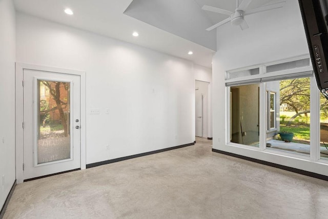 110 Forest Hls, Rockport, TX 78382 - spare room featuring healthy amount of natural light, finished concrete flooring, ceiling fan, a towering ceiling, and recessed lighting