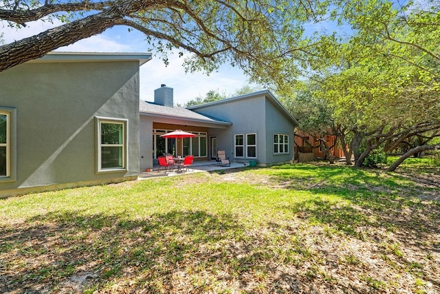 110 Forest Hls, Rockport, TX 78382 - rear view of house with a chimney, a patio, and stucco siding