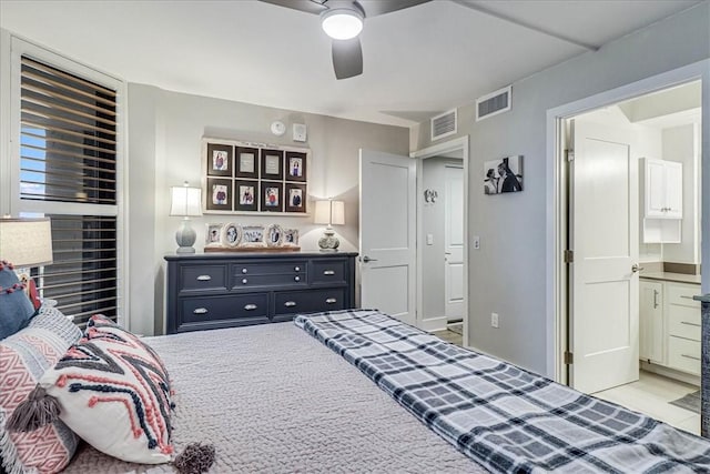 bedroom with ceiling fan and ensuite bath