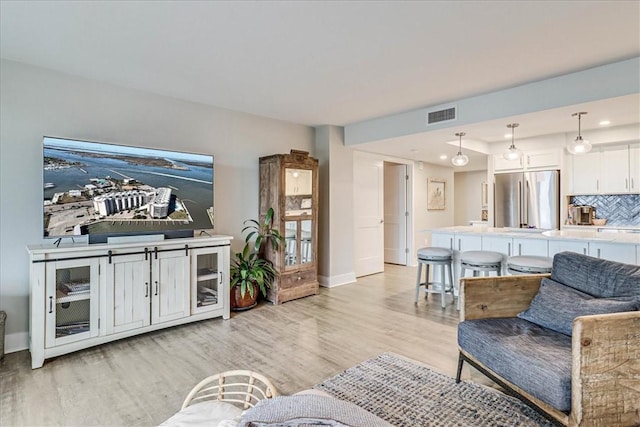 living room with light hardwood / wood-style floors