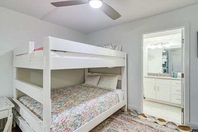 bedroom featuring ensuite bathroom, sink, and ceiling fan