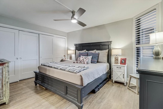 bedroom featuring light hardwood / wood-style floors, a closet, and ceiling fan