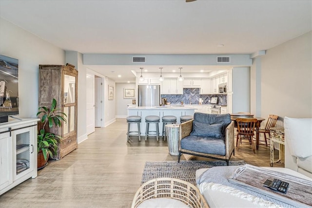 living room with light hardwood / wood-style flooring