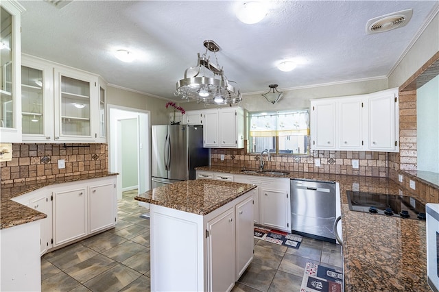 kitchen featuring white cabinetry, stainless steel appliances, and a kitchen island