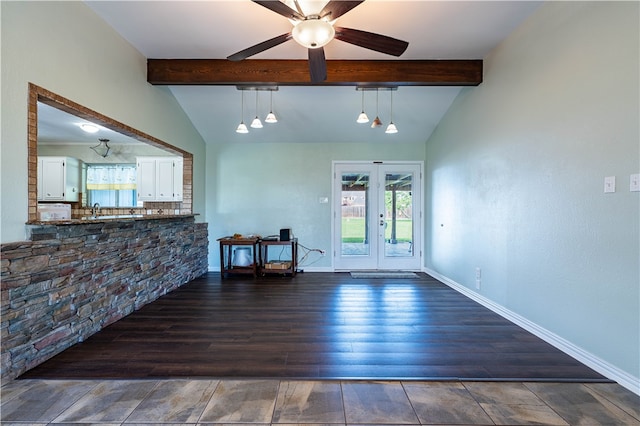 interior space with dark wood-type flooring, ceiling fan, vaulted ceiling with beams, and french doors