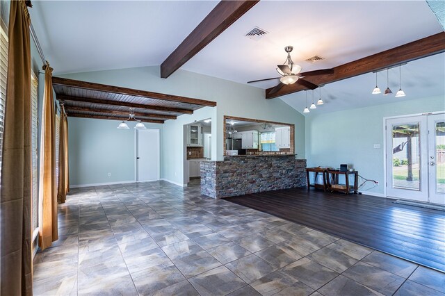 unfurnished living room featuring french doors, dark hardwood / wood-style flooring, vaulted ceiling with beams, and ceiling fan