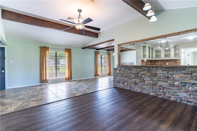 unfurnished living room with lofted ceiling with beams, ceiling fan with notable chandelier, and dark hardwood / wood-style flooring