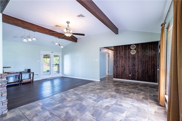 unfurnished living room with french doors, dark hardwood / wood-style flooring, vaulted ceiling with beams, wooden walls, and ceiling fan