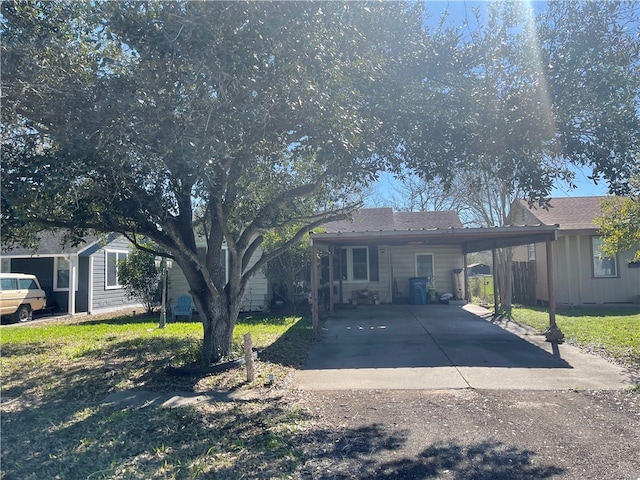 single story home featuring a front lawn and a carport