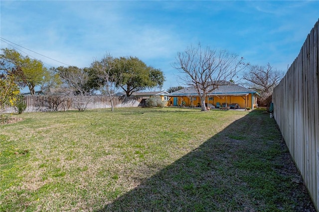 view of yard with a fenced backyard