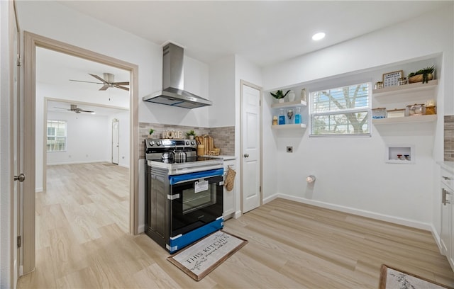 kitchen featuring tasteful backsplash, light countertops, electric range, white cabinetry, and wall chimney exhaust hood