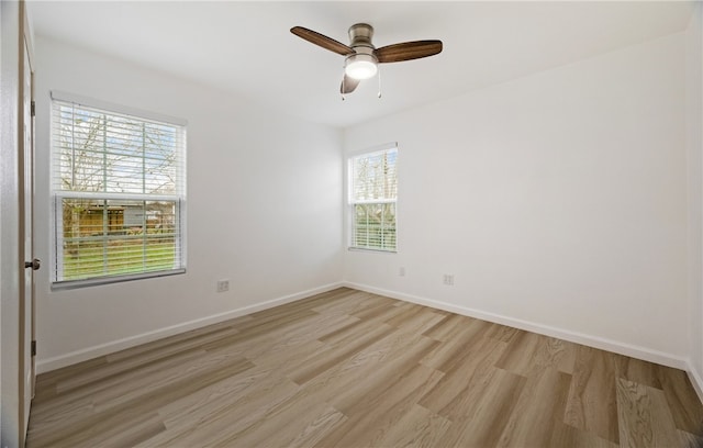 unfurnished room with light wood-style floors, baseboards, and a ceiling fan