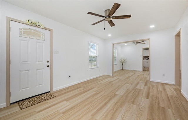 empty room featuring light wood-type flooring, baseboards, and recessed lighting