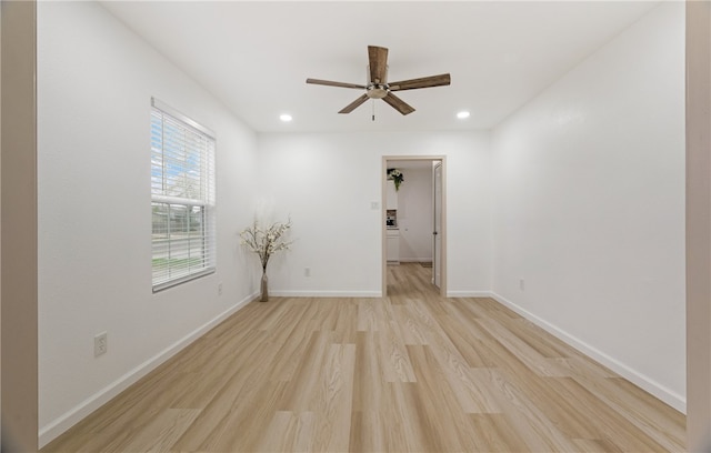 empty room featuring light wood-style floors, recessed lighting, ceiling fan, and baseboards