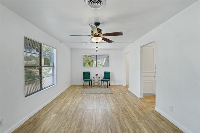 unfurnished room with ceiling fan and light hardwood / wood-style flooring