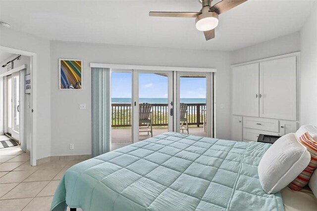 5973 State Highway 361 Unit 436, Port Aransas, TX 78373 - bedroom featuring access to exterior, light tile patterned floors, a water view, and a ceiling fan