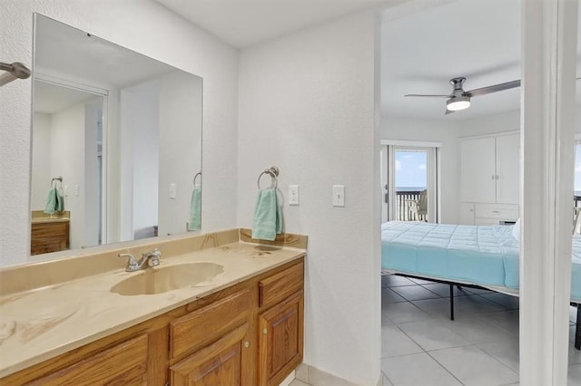 5973 State Highway 361 Unit 436, Port Aransas, TX 78373 - ensuite bathroom with vanity, tile patterned floors, a ceiling fan, and a textured wall