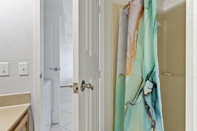 5973 State Highway 361 Unit 436, Port Aransas, TX 78373 - full bath featuring tile patterned flooring, vanity, curtained shower, and a textured wall